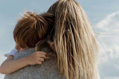 woman in gray shirt covering her face with her hair